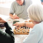 Older adults enjoy chess and conversation—social engagement for seniors in action.